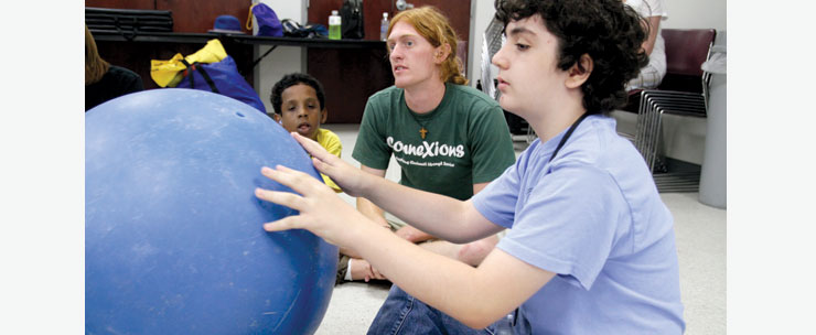 Young blind boy playing with ball